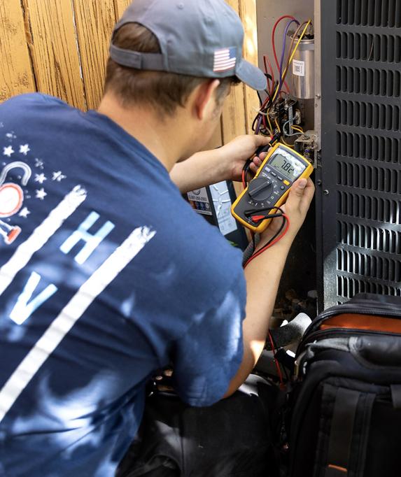 Technician checking HVAC unit