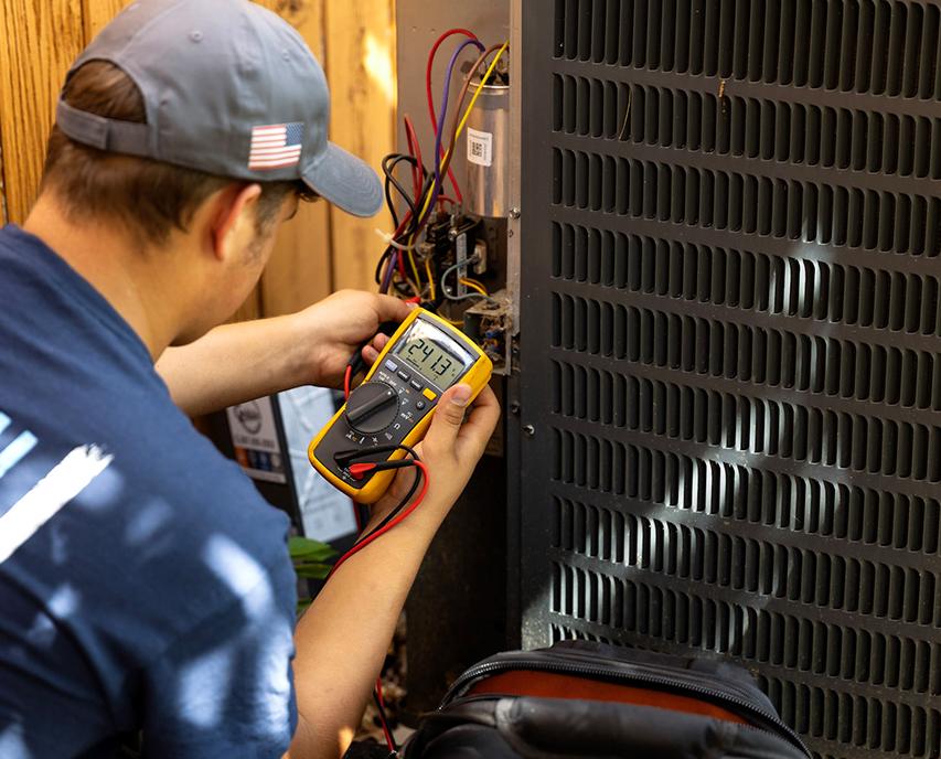 Technician working on hvac unit
